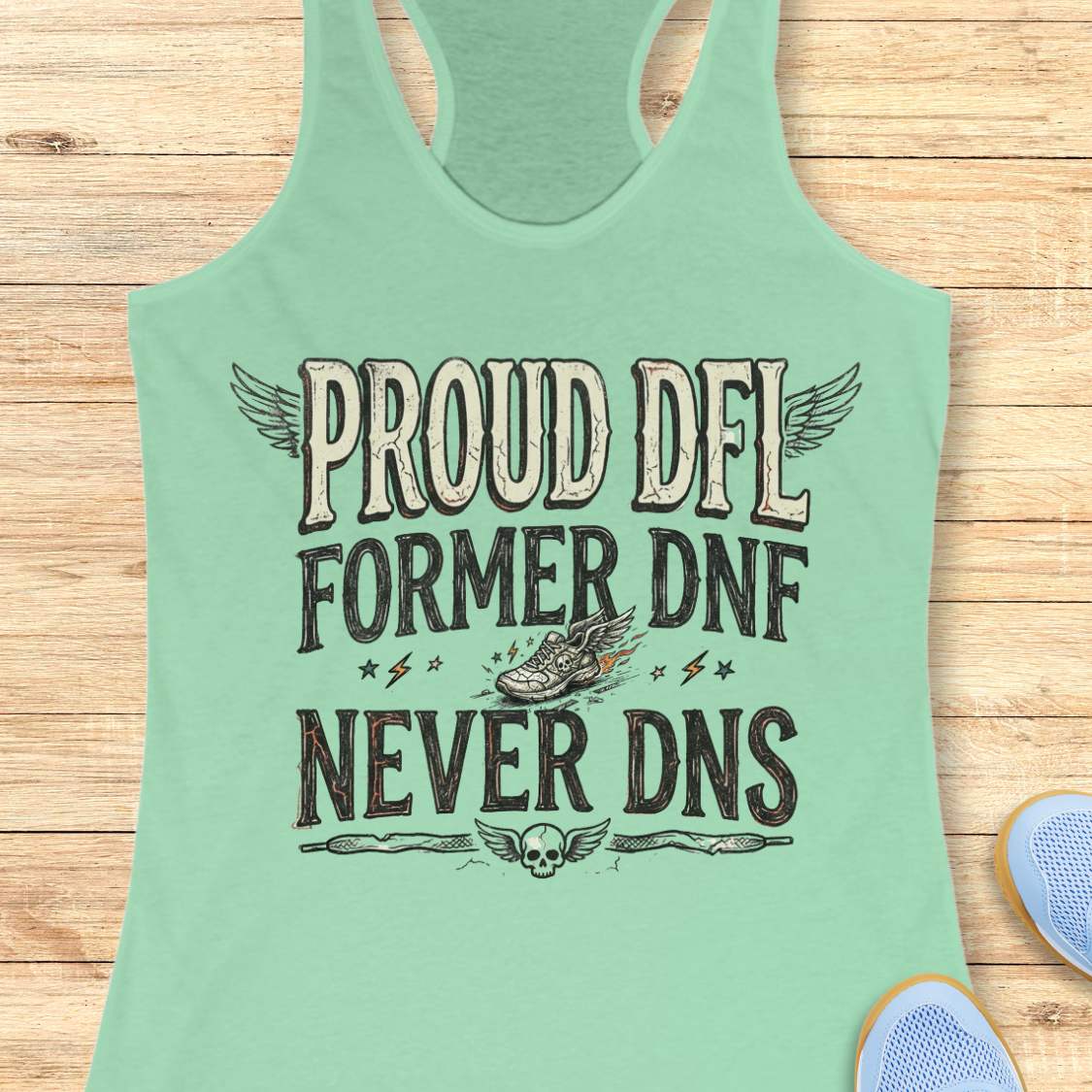 Mint green tank top with text 'Proud DFL, former DNF, never DNS', on a wooden surface