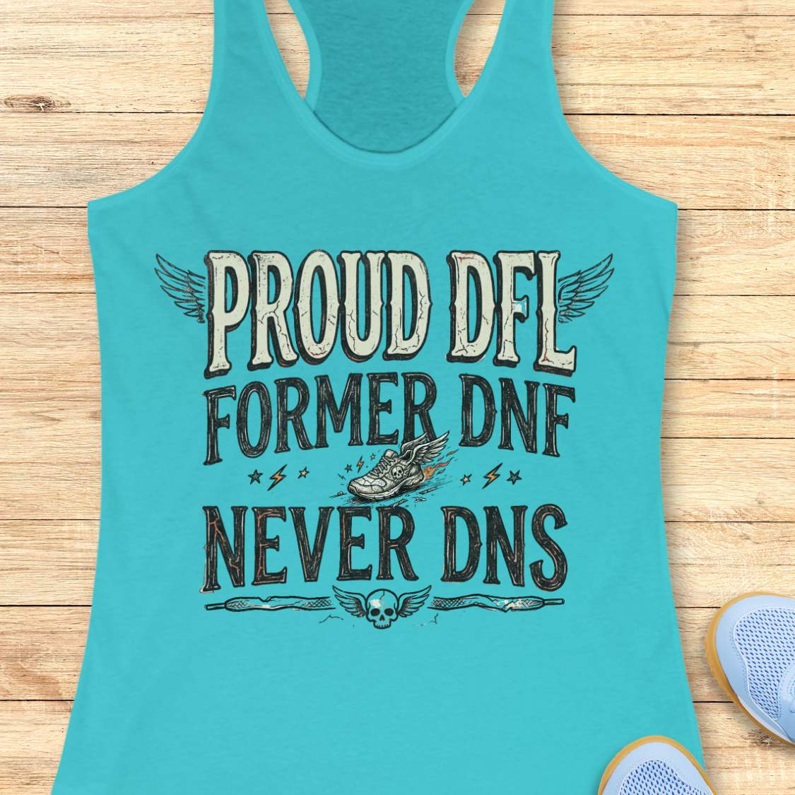 Turquoise tank top with text 'Proud DFL, former DNF, never DNS',  on a wooden surface
