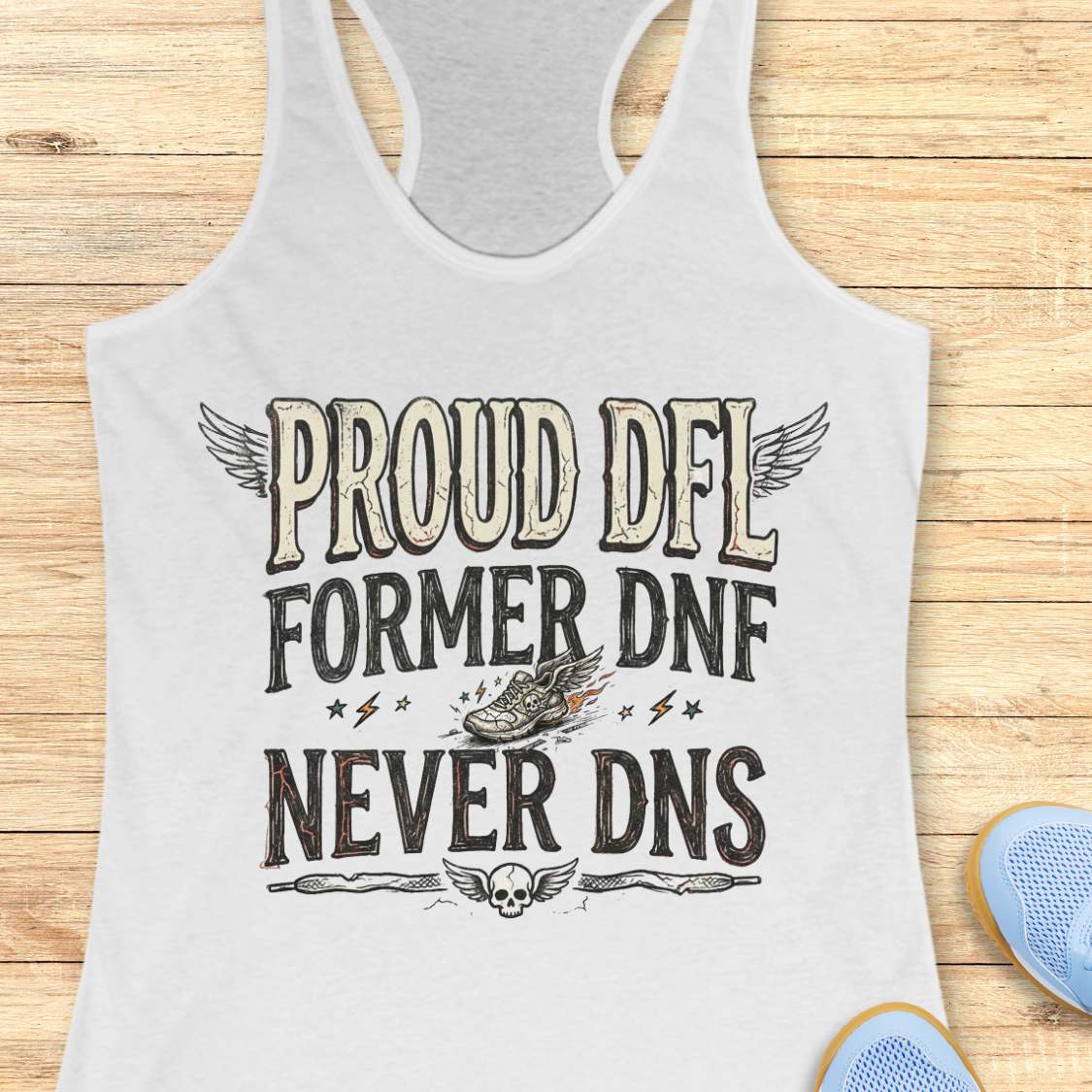 white tank top with text 'Proud DFL, former DNF, never DNS', on a wooden surface