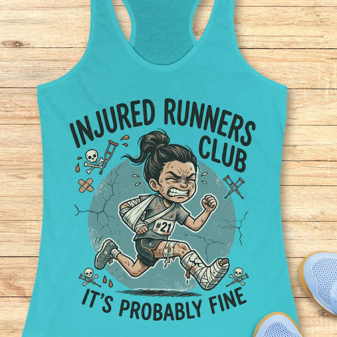 Turquoise tank top with 'Injured Runners Club' graphic on a wooden surface