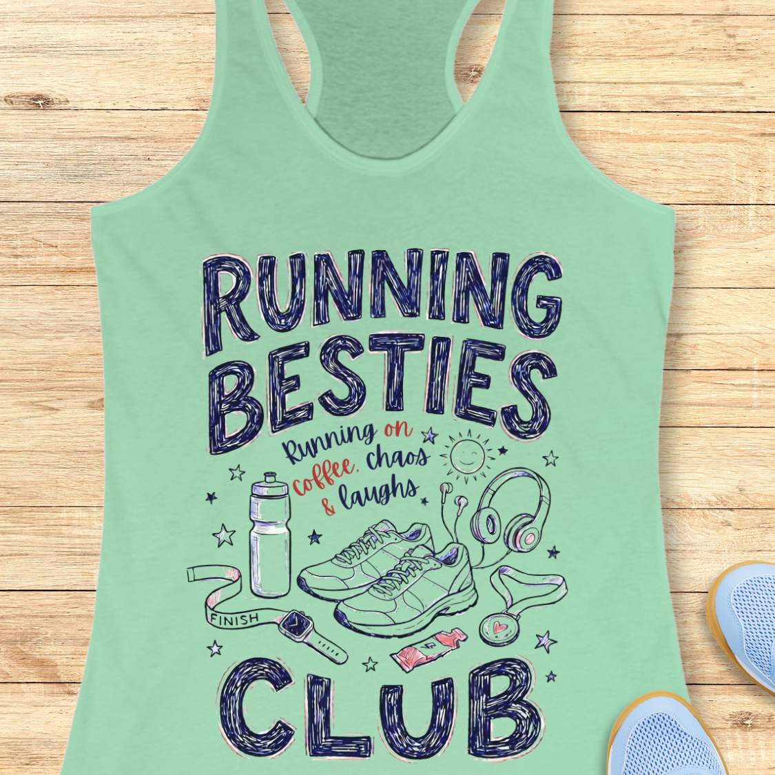 Mint green tank top with 'Running Besties Club' text and graphics on a wooden surface