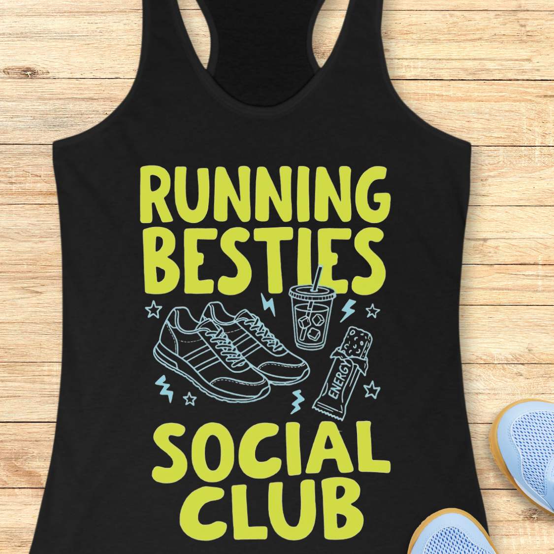 Black tank top with 'Running Besties Social Club' text and graphics on a wooden surface.