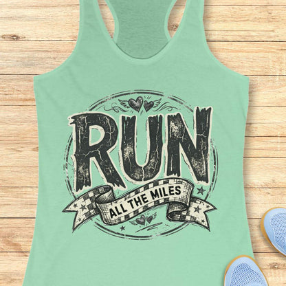 Mint green tank top with 'RUN ALL THE MILES' text on a wooden surface