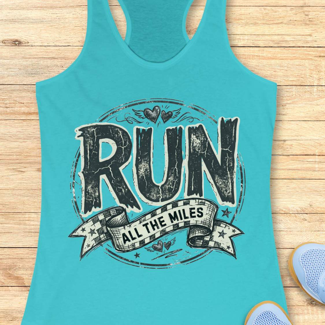 Turquoise tank top with 'RUN ALL THE MILES' text on a wooden surface
