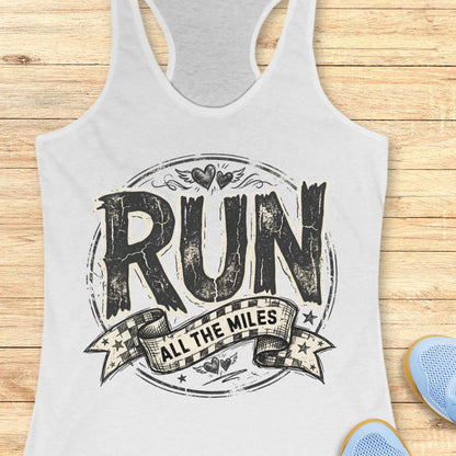 white tank top with 'RUN ALL THE MILES' text on a wooden surface
