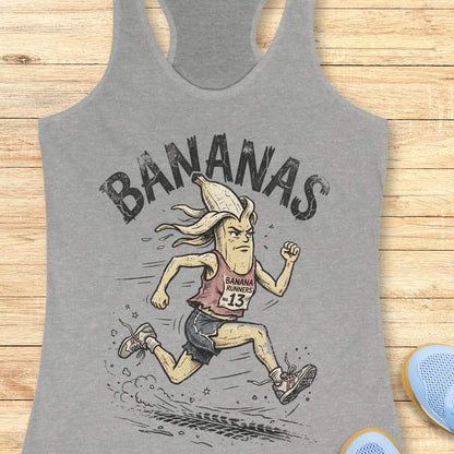 Gray tank top with cartoon banana character and 'BANANAS' text on a wooden surface