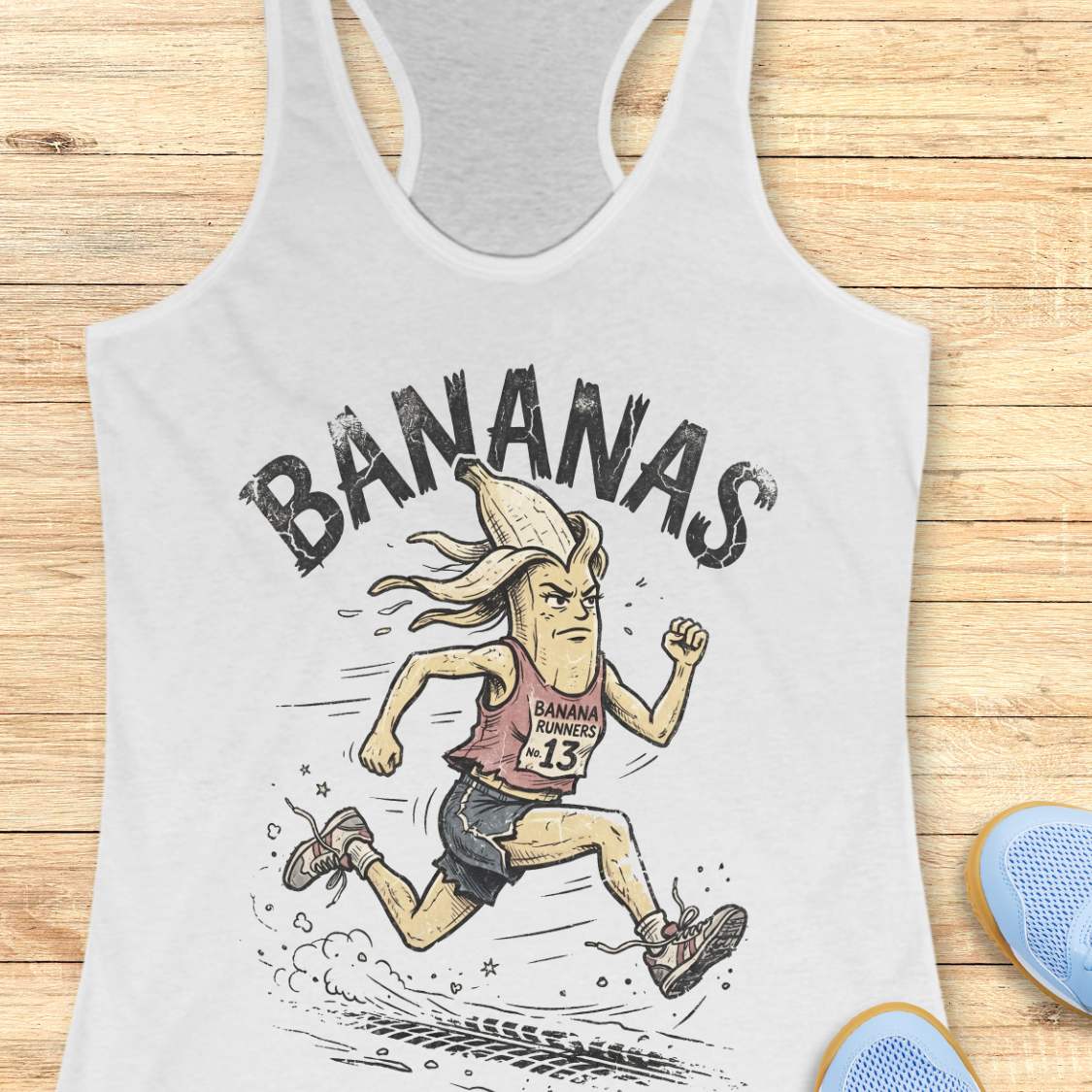 white tank top with cartoon character and 'BANANAS' text on a wooden surface