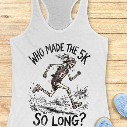 white tank top with skeleton running graphic and text 'WHO MADE THE 5K SO LONG?' on a wooden surface.