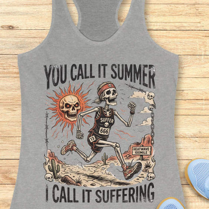 Gray tank top with skeleton graphic and text 'you call it summer, I call it suffering',  on a wooden surface