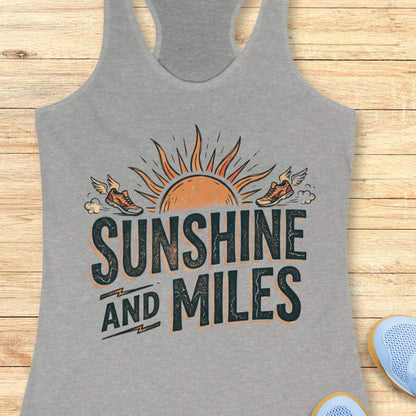Gray tank top with 'Sunshine and Miles' design on a wooden surface