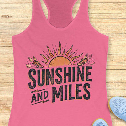 Pink tank top with 'Sunshine and Miles' design on a wooden surface