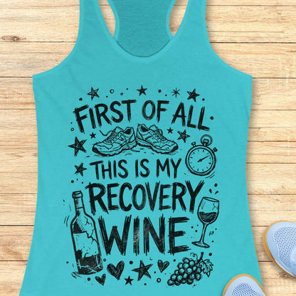 Turquoise tank top with humorous text 'first of all, this is my recovery wine',  and graphics on a wooden surface