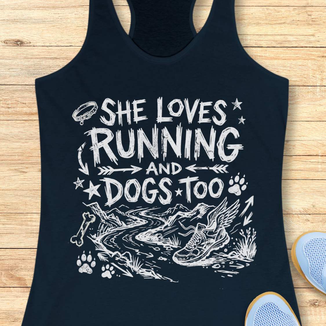 navy tank top with white text 'she loves running and dogs too', and graphics on a wooden surface