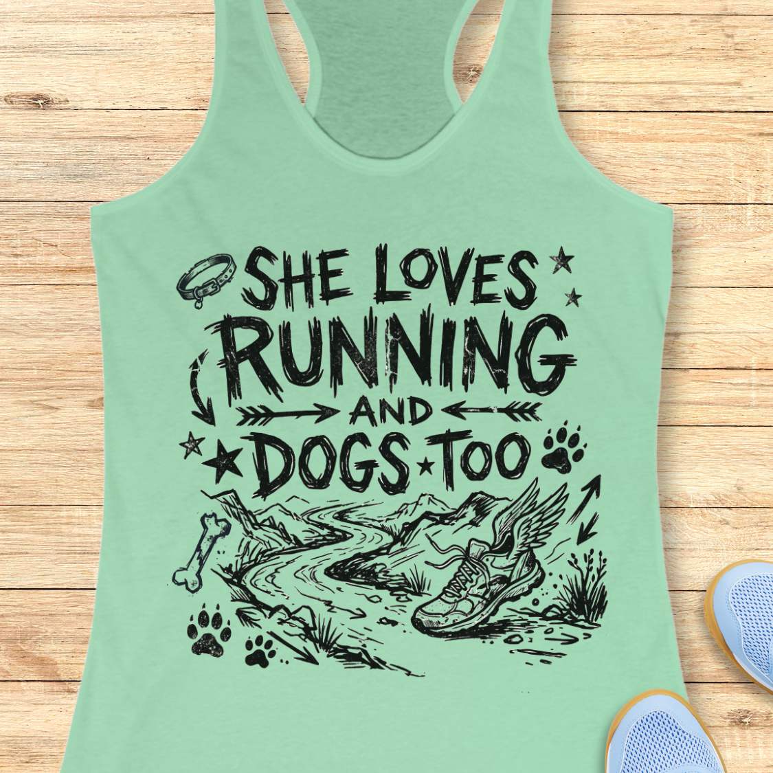 Green tank top with text 'She loves running and dogs too' on a wooden surface
