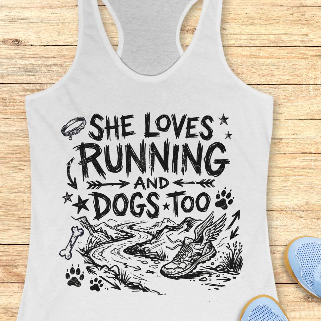 white tank top with 'She loves running and dogs too' text and graphics on a wooden surface.