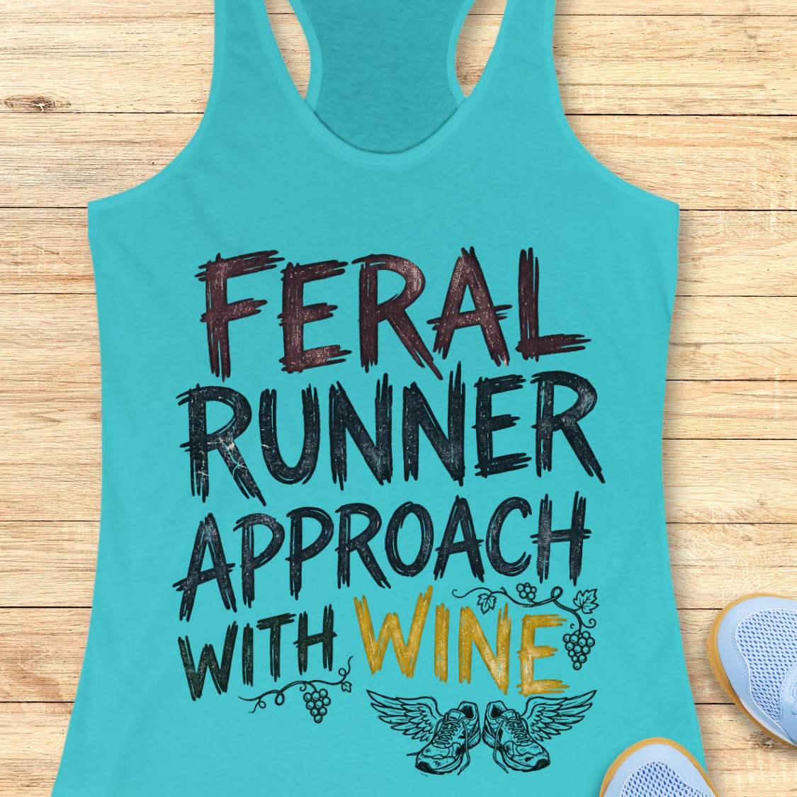 blue tank top with black graphic design and text 'feral runner approach with wine', on a wooden surface