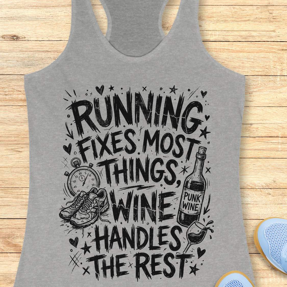 grey tank top with black graphic design and text 'running fixes most things, wine handles the rest', on a wooden surface