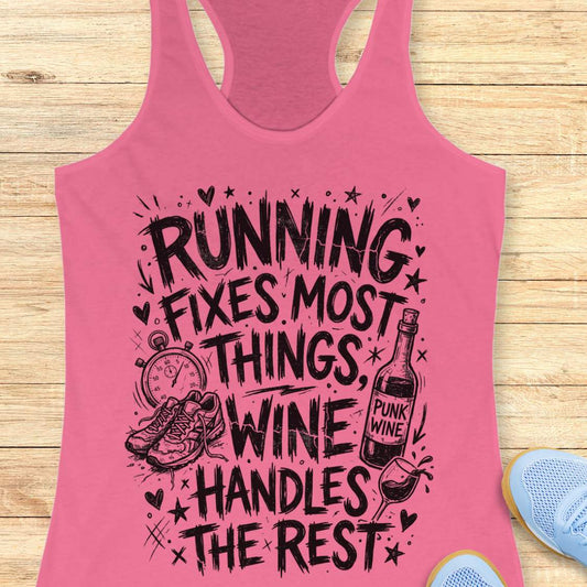 pink tank top with black graphic design and text 'running fixes most things, wine handles the rest', on a wooden surface
