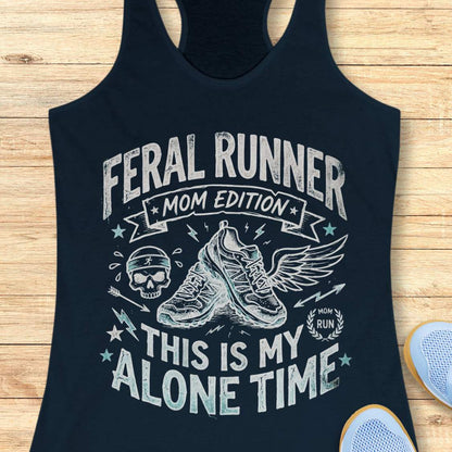 navy tank top with black graphic design and text 'feral runner, mom edition. This is my alone time', on a wooden surface