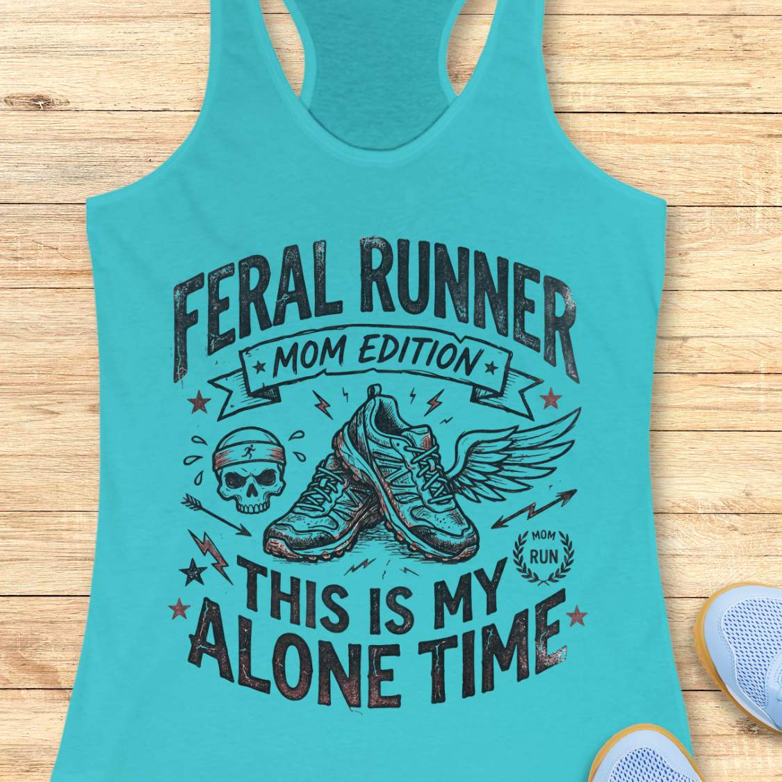 blue tank top with black graphic design and text 'feral runner, mom edition. This is my alone time', on a wooden surface