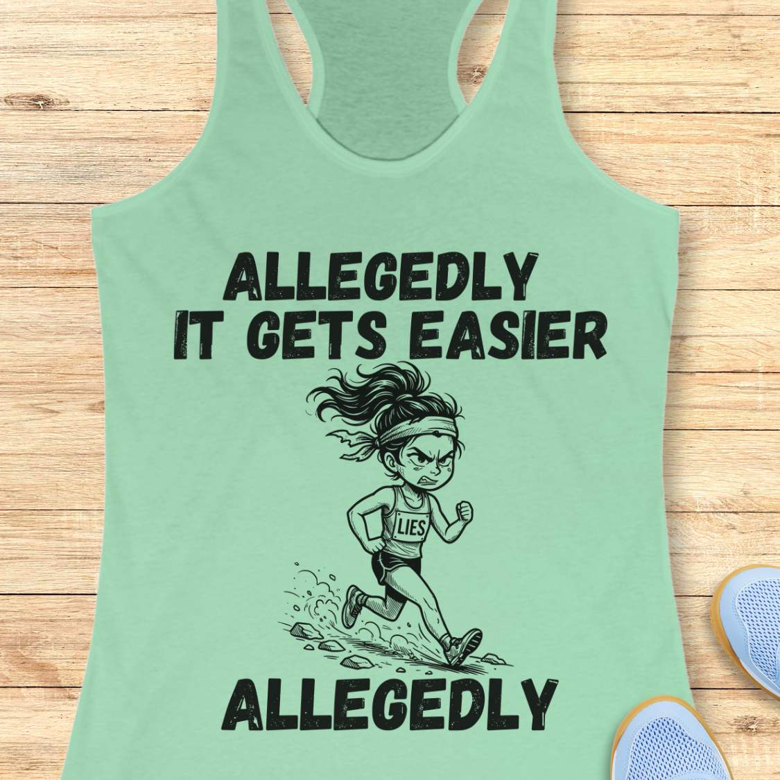 mint tank top with black graphic design and text 'allegedly it gets easier. Allegedly.', on a wooden surface