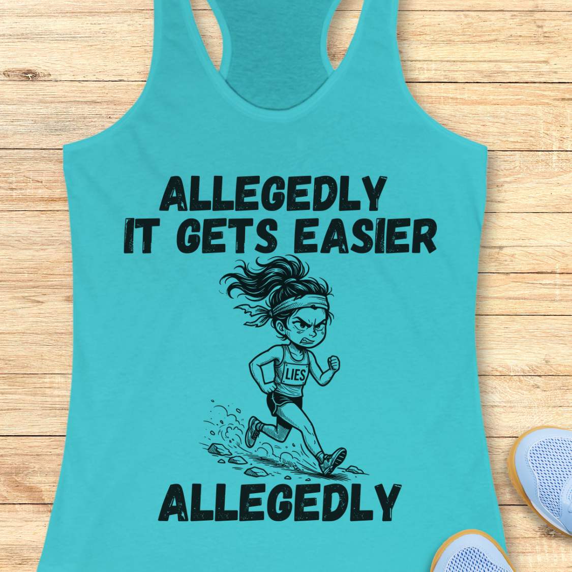 blue tank top with black graphic design and text 'allegedly it gets easier. Allegedly.', on a wooden surface