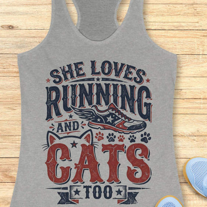 grey tank top with graphic design and text 'She loves running and cats too.', on a wooden surface
