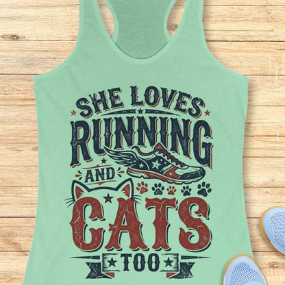 mint tank top with graphic design and text 'She loves running and cats too.', on a wooden surface