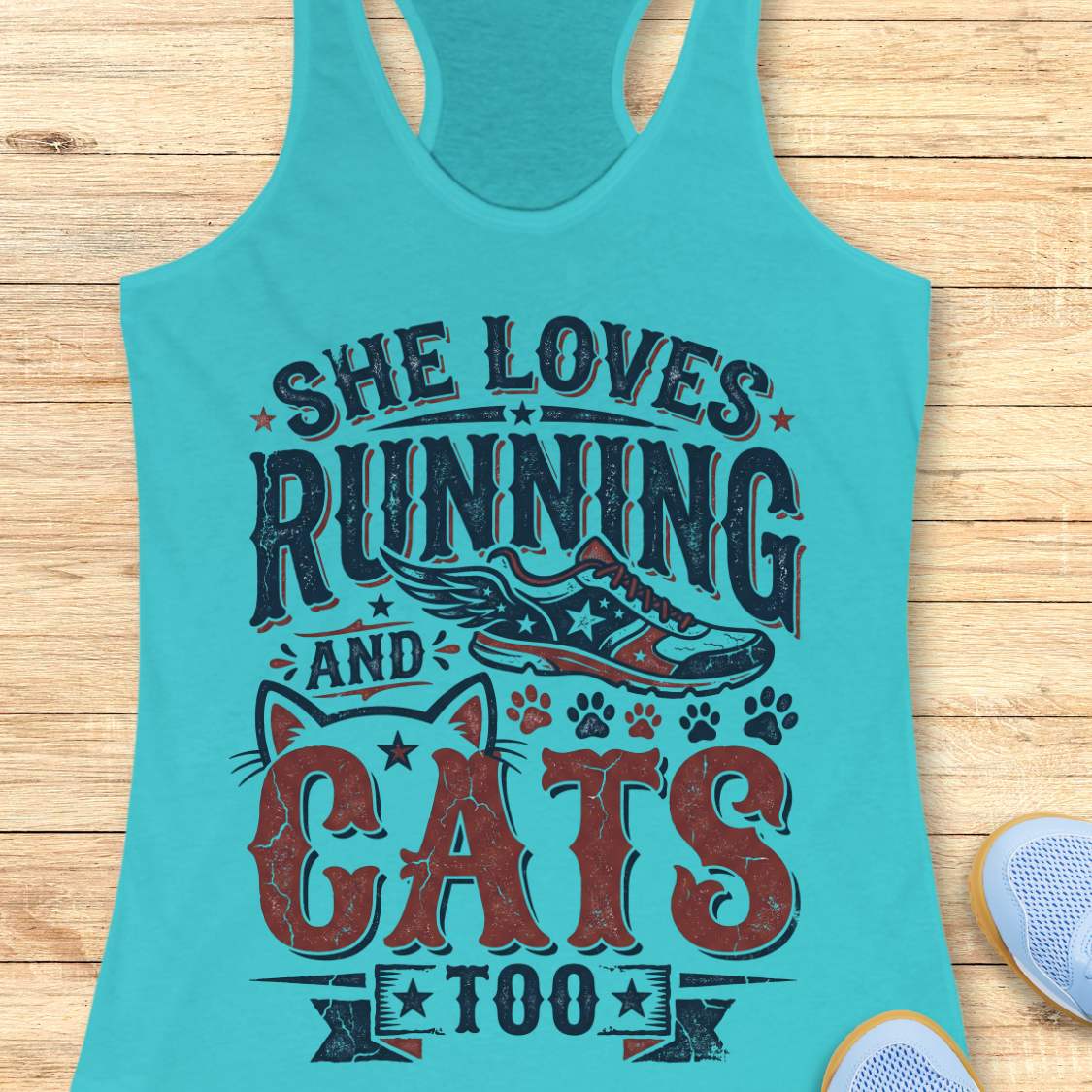 blue tank top with graphic design and text 'She loves running and cats too.', on a wooden surface