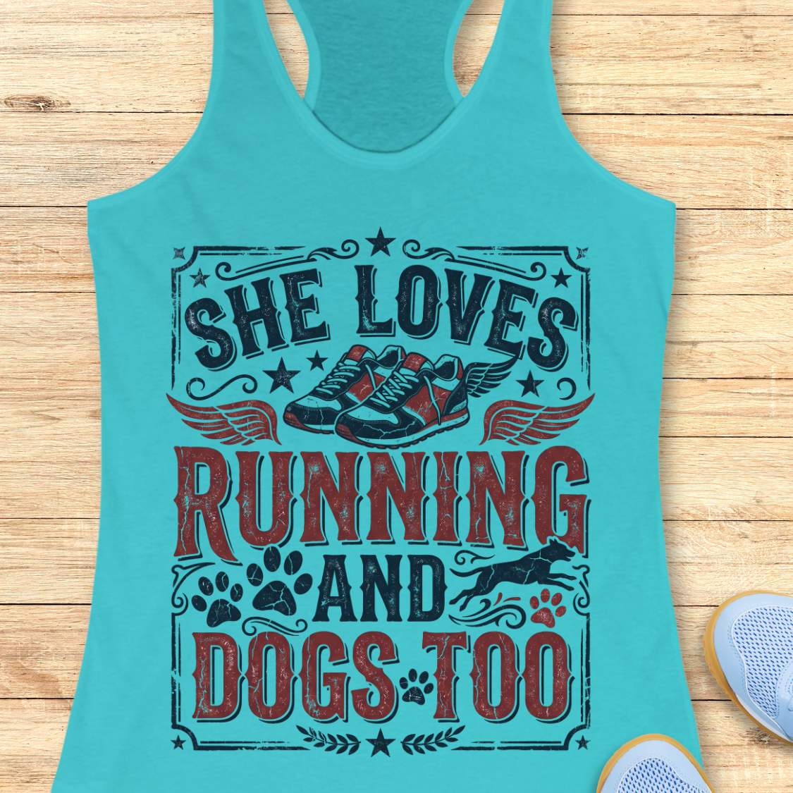 blue tank top with graphic design and text 'She loves running and dogs too.', on a wooden surface