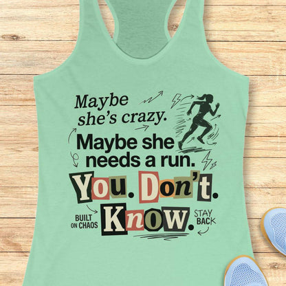 mint tank top with graphic design and text 'Maybe she's crazy. Maybe she needs a run. You. Don't. Know.', on a wooden surface