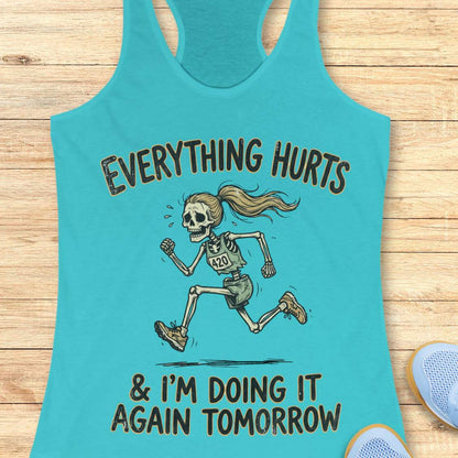 blue tank top with graphic design of a runner skeleton and text 'Everything hurts and I'm doing it again tomorrow', on a wooden surface
