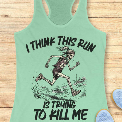 mint tank top with graphic design of a runner skeleton and text 'I think this run is trying to kill me', on a wooden surface