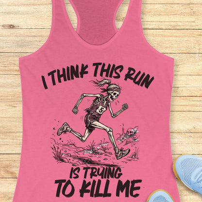 pink tank top with graphic design of a runner skeleton and text 'I think this run is trying to kill me', on a wooden surface