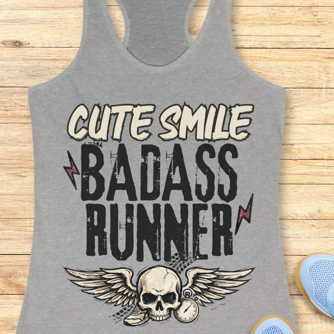 grey tank top with text 'cute smile badass runner, on a wooden surface