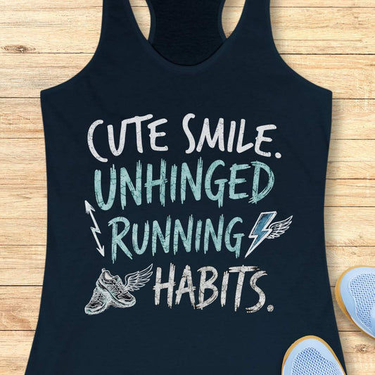 navy tank top with text 'cute smile unhinged running habits', on a wooden surface