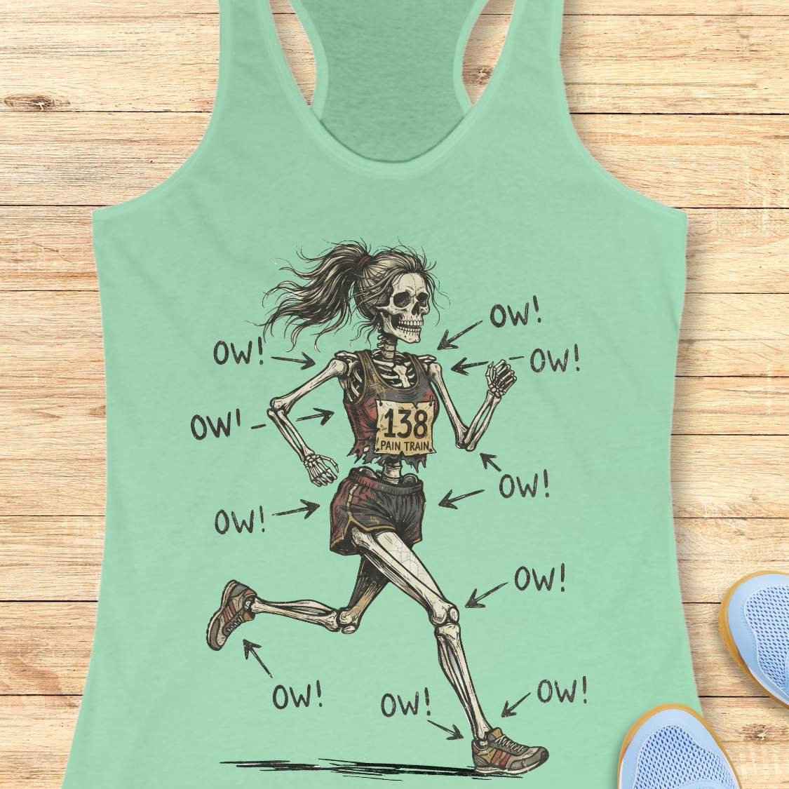 mint tank top with a running skeleton, on a wooden surface