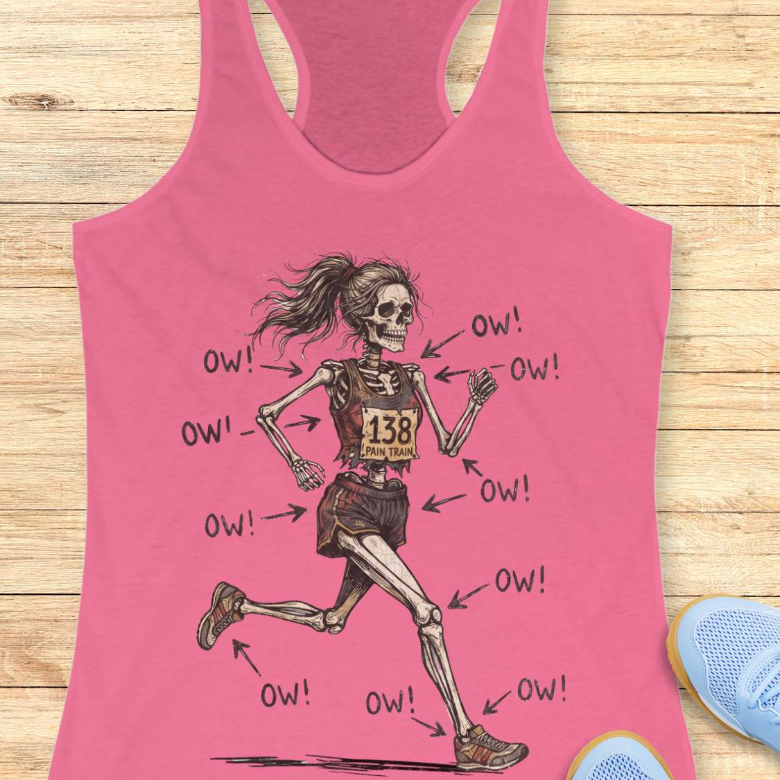 pink tank top with a running skeleton, on a wooden surface