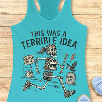 blue tank top with a running skeleton and text 'This was a terrible idea', on a wooden surface