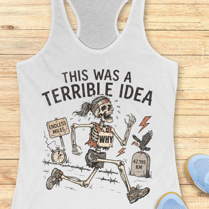 white tank top with a running skeleton and text 'This was a terrible idea', on a wooden surface