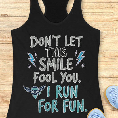 black tank top with text 'Don't let this smile fool you. I run for fun', on a wooden surface