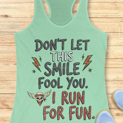 mint tank top with text 'Don't let this smile fool you. I run for fun', on a wooden surface