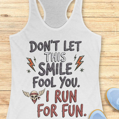 white tank top with text 'Don't let this smile fool you. I run for fun', on a wooden surface