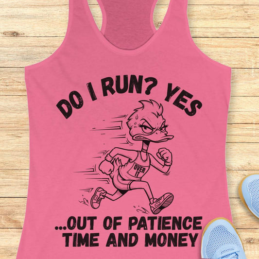 A pink racerback tank top laid flat on a light wood surface, featuring a black graphic of a running duck with the text 'DO I RUN? YES .