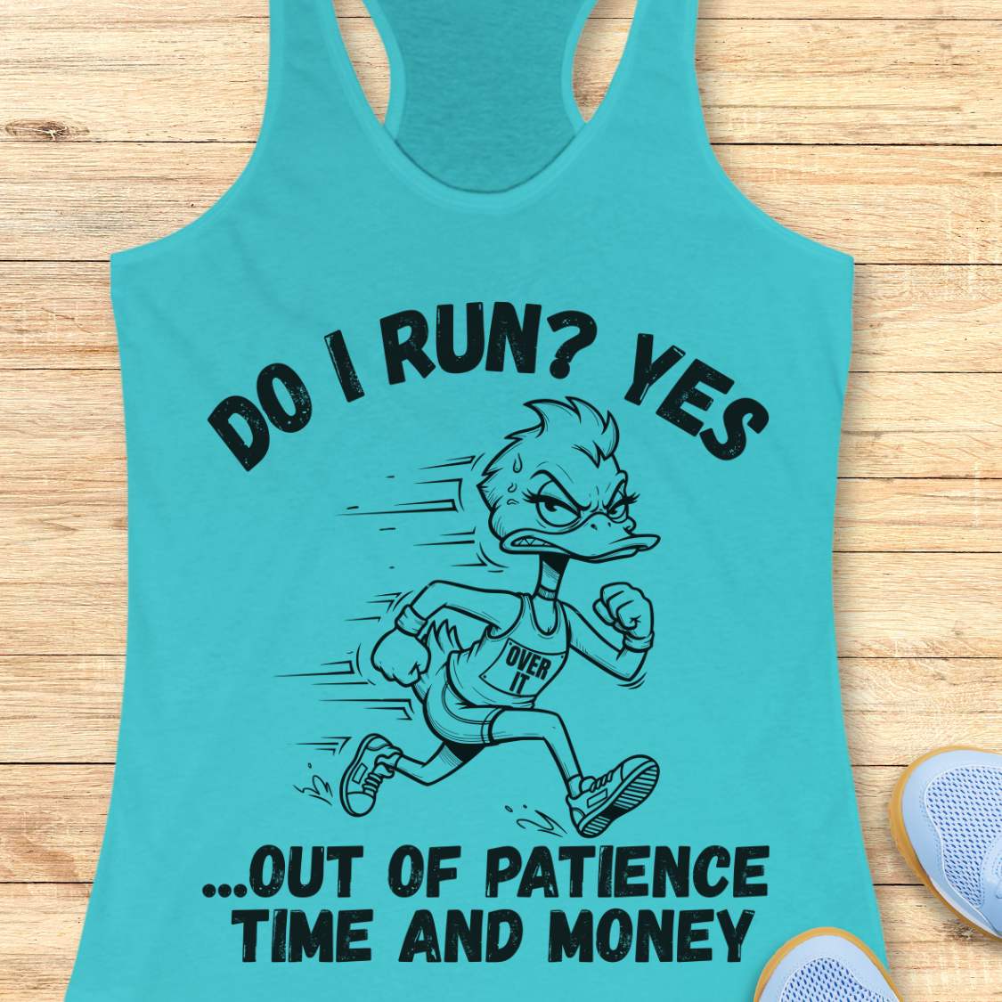 A turquoise racerback tank top laid flat on a light wood surface, featuring a black graphic of a running duck with the text 'DO I RUN? YES .