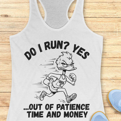 A white racerback tank top laid flat on a light wood background, featuring a black graphic of a cartoon duck running with the text 'DO I RUN? YES .