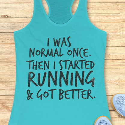 A turquoise racerback tank top with black distressed text reading 'I WAS NORMAL ONCE. THEN I STARTED RUNNING & GOT BETTER.