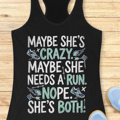 A black racerback tank top laid flat on a light wood background, featuring a humorous graphic with white and mint green text that reads 'MAYBE SHE'S CRAZY. MAYBE SHE NEEDS A RUN.