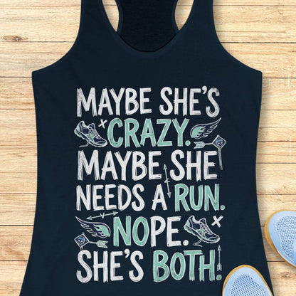 A navy blue racerback tank top with a humorous graphic print, laid flat on a light wood background with a pair of running shoes partially visible in the corner.