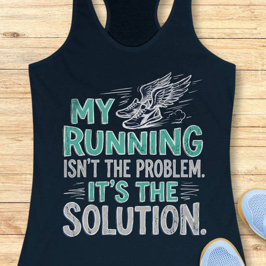 A navy blue racerback tank top laid flat on a light wood background, featuring a graphic print with the text 'MY RUNNING ISN'T THE PROBLEM. IT'S THE SOLUTION.
